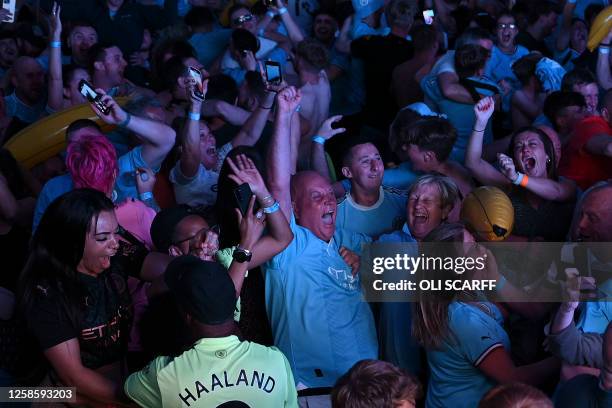 Manchester City fans celebrate after their club beat Inter Milan to win the UEFA Champions League final football match in Istanbul at 4TheFans Fan...