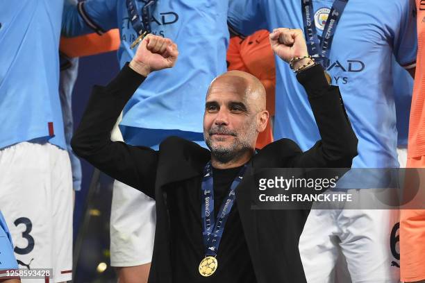 Manchester City's Spanish manager Pep Guardiola celebrates with the winners' medal after winning the UEFA Champions League final football match...