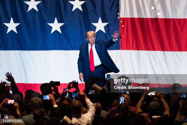 Former US President Donald Trump waves to attendees after speaking during the Georgia GOP State Convention in Columbus, Georgia, on Saturday, June...