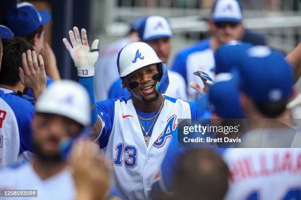 Ronald Acuna Jr. #13 of the Atlanta Braves celebrates with teammates after hitting a two-run home run against the Washington Nationals in the second...