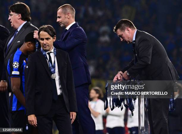Inter Milan's Italian head coach Simone Inzaghi receives his runners-up medal after their defeat in the UEFA Champions League final football match...