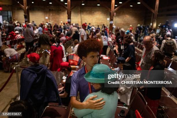 Two people embrace after former US President Donald Trump spoke at the Georgia Republican Party's 2023 State Convention in Columbus, Georgia, on June...