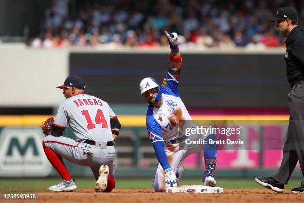 Kevin Pillar of the Atlanta Braves reacts after a double in front of Ildemaro Vargas of the Washington Nationals in the second inning at Truist Park...