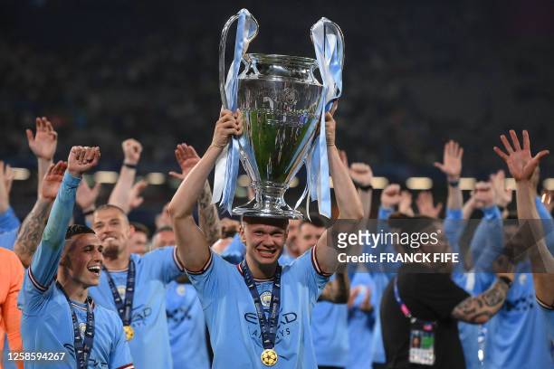 Manchester City's Norwegian striker Erling Haaland celebrates with the European Cup trophy after winning the UEFA Champions League final football...
