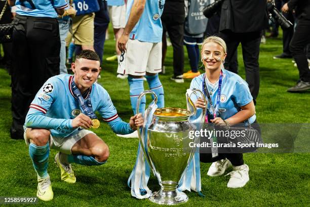 Phil Foden of Manchester City celebrates the UEFA Champions league title with Rebecca Cooke after winning FC Internazionale during the UEFA Champions...