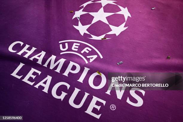 Confetti covers a carpet bearing the logo of the UEFA Champions League after the final football match between Inter Milan and Manchester City at the...