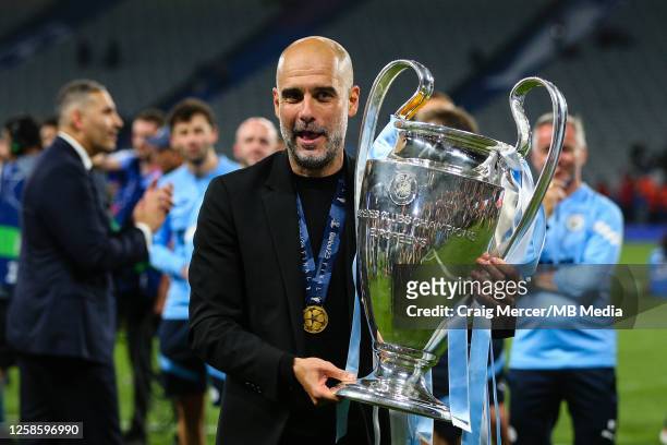 Manchester City manager Pep Guardiola poses with the trophy after the UEFA Champions League 2022/23 final match between FC Internazionale and...