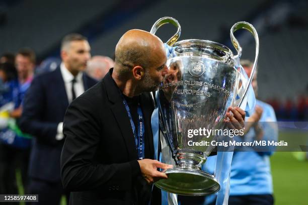 Manchester City manager Pep Guardiola kisses the trophy after the UEFA Champions League 2022/23 final match between FC Internazionale and Manchester...