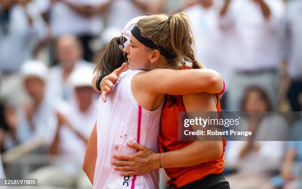 Iga Swiatek of Poland and Karolina Muchova of the Czech Republic embrace after the Women's singles final on Day Fourteen of Roland Garros on June 10,...