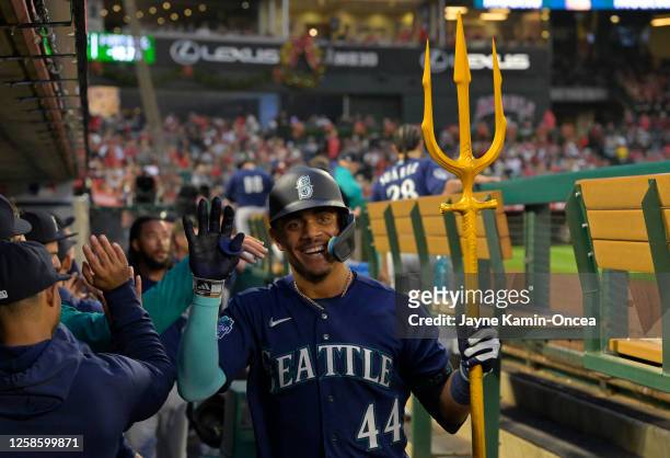 Julio Rodriguez of the Seattle Mariners is congratulated in the dugout after hitting a two run home run in the third inning against the Los Angeles...