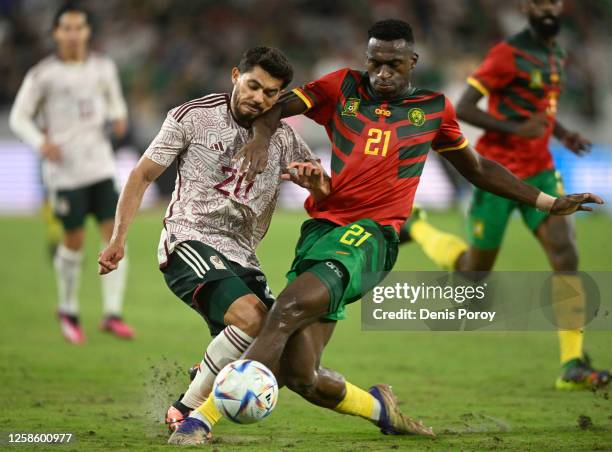 Henry Martin of Mexico fights for the ball with Oumar Gonzalez of Cameroon during the second half of the Mextour soccer match June 10, 2023 at...
