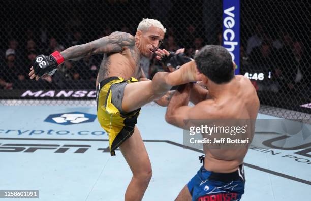 Charles Oliveira of Brazil kicks Beneil Dariush of Iran in their lightweight fight during the UFC 289 event at Rogers Arena on June 10, 2023 in...
