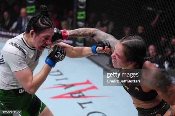 Amanda Nunes of Brazil punches Irene Aldana of Mexico in their women's bantamweight title fight during the UFC 289 event at Rogers Arena on June 10,...