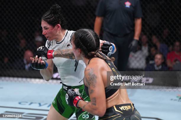 Amanda Nunes of Brazil punches Irene Aldana of Mexico in their women's bantamweight title fight during the UFC 289 event at Rogers Arena on June 10,...