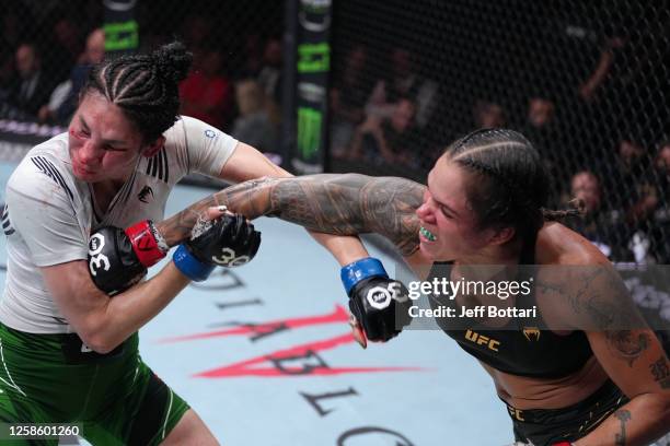 Amanda Nunes of Brazil punches Irene Aldana of Mexico in their women's bantamweight title fight during the UFC 289 event at Rogers Arena on June 10,...