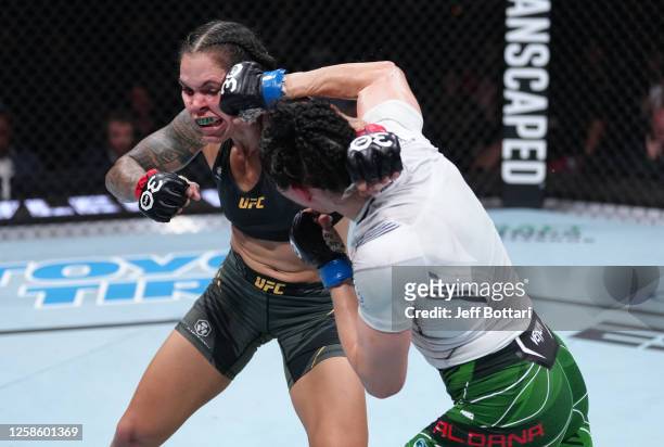 Irene Aldana of Mexico punches Amanda Nunes of Brazil in their women's bantamweight title fight during the UFC 289 event at Rogers Arena on June 10,...