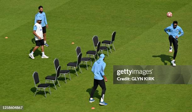 India's cricketers including captain Rohit Sharma warm up with a game of football ahead of play on day 5 of the ICC World Test Championship cricket...