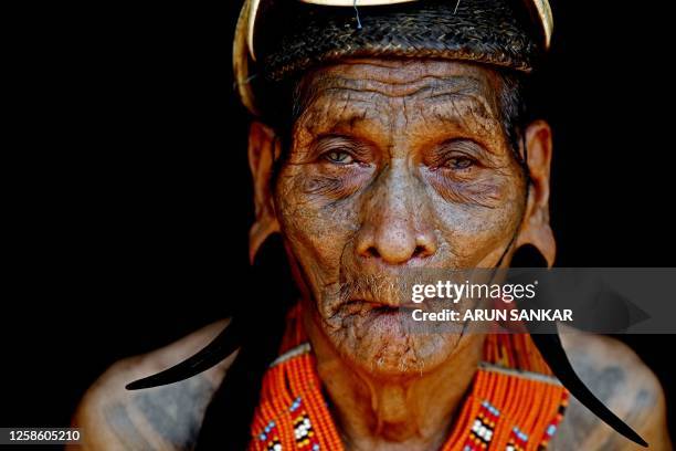 This photograph taken on April 8, 2023 shows a Konyak tribesman during a community gathering in Hongphoi village, in the northeast Indian state of...