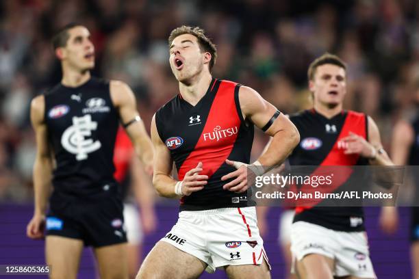 Zach Merrett of the Bombers reacts during the 2023 AFL Round 13 match between the Carlton Blues and the Essendon Bombers at the Melbourne Cricket...