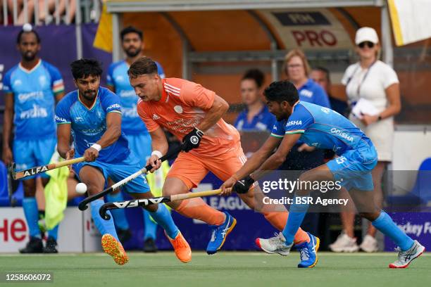 Pepijn Reyenga of the Netherlands and Raj Kumar Pal of India and Abhishek of India during the 2022/2023 FIH Hockey Pro League match between...