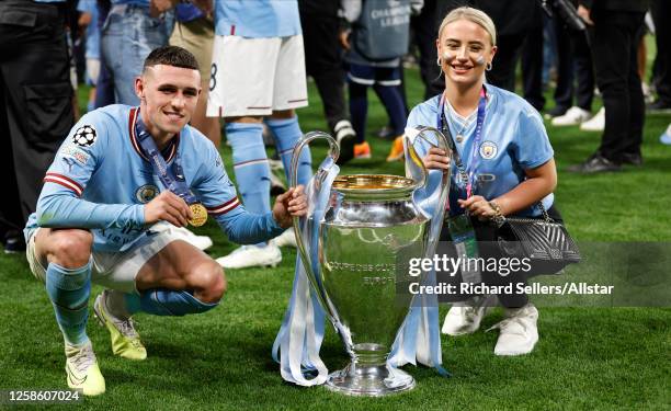 Phil Foden of Manchester City and Rebecca Cooke celebrate with trophy after winning the UEFA Champions League 2022/23 final match between FC...