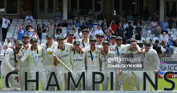 Australia's Pat Cummins lifts the ICC Test Championship Mace as he celebrates with teammates after victory in the ICC World Test Championship cricket...