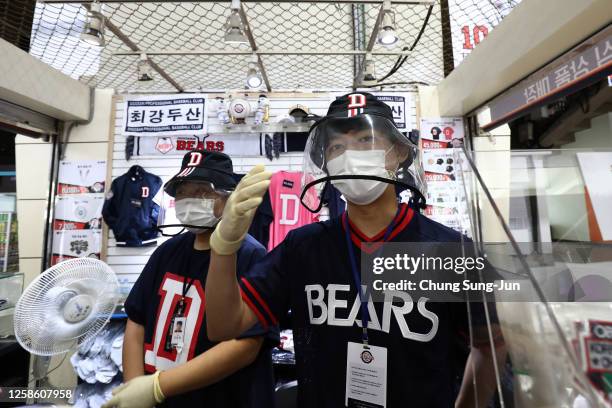 Baseball merchandise shop staffs ahead of the KBO League game between LG Twins and Doosan Bears at the Jamsil Stadium on July 26, 2020 in Seoul,...