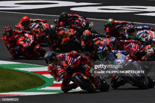 Pack of riders compete at the start of the race during the Italian MotoGP race at Mugello Circuit in Mugello, on June 11, 2023.