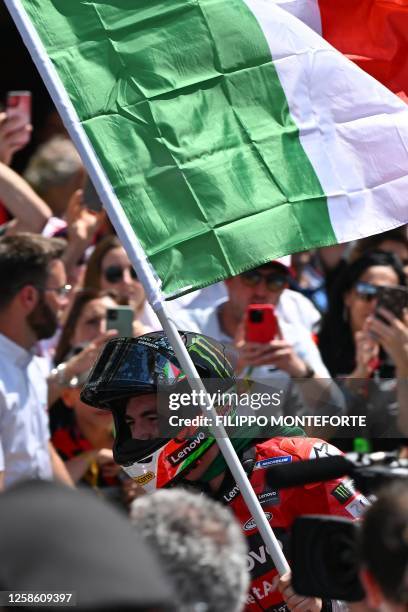 Ducati Italian rider Francesco Bagnaia waves the Italian flag as he celebrates after winning the Italian MotoGP race at Mugello Circuit in Mugello,...