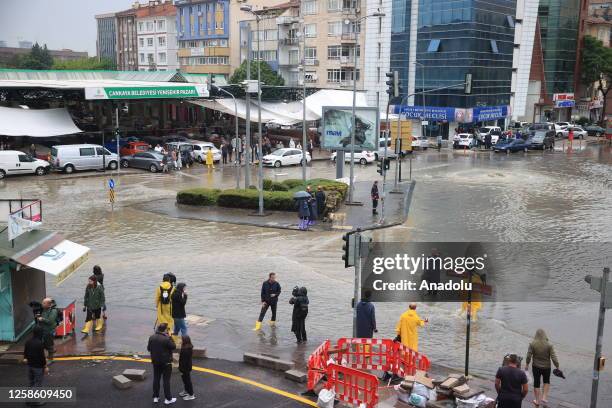 People waiting in indoor areas and vehicles had difficulty in advancing due to the water as some vehicles were submerged on streets after heavy rains...