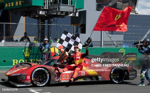 Ferrari N.51 499P Hypercar drivers British James Calado and Italian Antonio Giovinazzi join Italian Alessandro Pier Guidi to celebrate after winning...