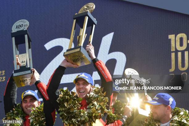 Ferrari N.51 499P Hypercar drivers Italian Alessandro Pier Guidi, British James Calado and Italian Antonio Giovinazzi celebrate on the podium after...