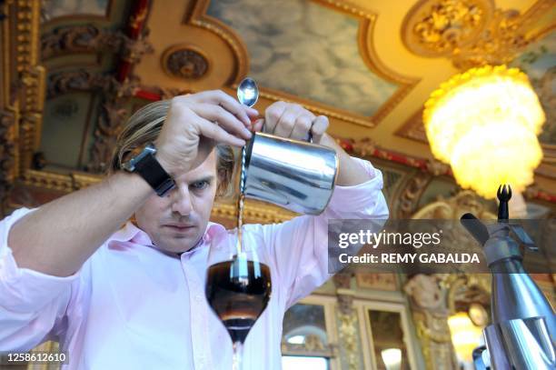 Barman prepares a Cafe Liegeois, a cold dessert, in the famous restaurant the "Bibent" on August 1, 2011 on the Place du Capitole in Toulouse,...