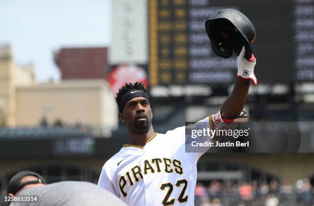 Andrew McCutchen of the Pittsburgh Pirates waves to the crowd after hitting a single for his 2000th career hit in the first inning during the game...