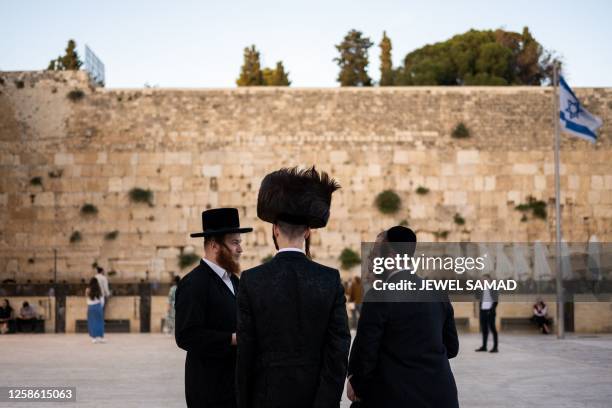 Ultra-Orthodox Jewish devotees arrive to pray at the Western Wall in the Old City of Jerusalem on June 11, 2023.
