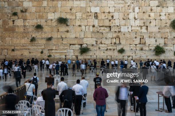 Jewish devotees pray at the Western Wall in the Old City of Jerusalem on June 11, 2023.