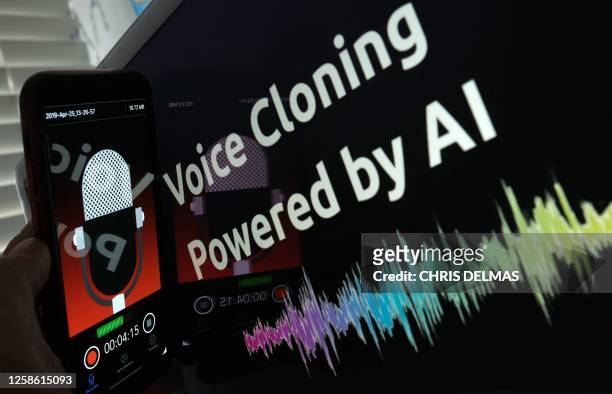 This illustration image created on June 9 shows a smartphone recording in front of a voice cloning screen in Los Angeles. The biggest peril of...
