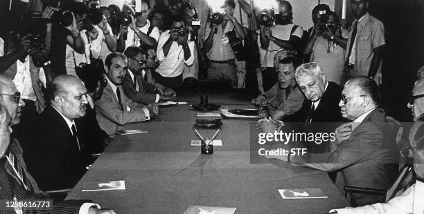 Israeli Defense Minister Ariel Sharon and Prime Minister Menahem Begin take part in a meeting with Egyptian Foreign Minister Kamal Hassan Ali 26...