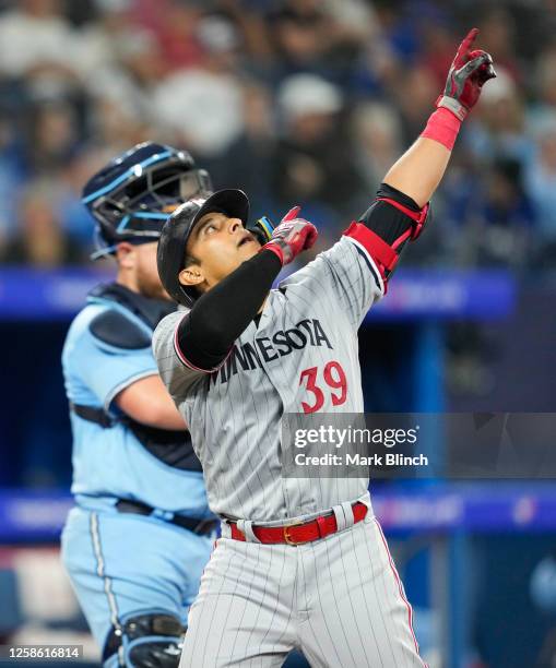 Donovan Solano of the Minnesota Twins celebrates his home run against the Toronto Blue Jays during the fifth inning in their MLB game at the Rogers...