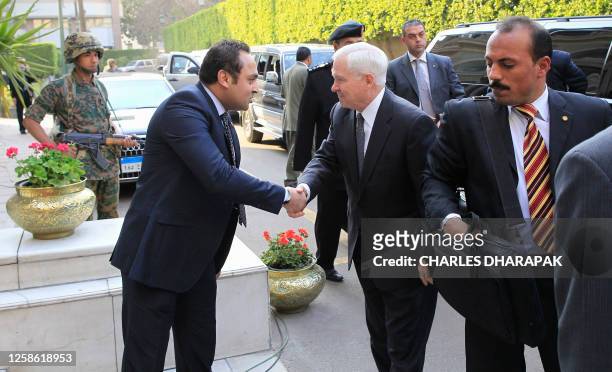 Defense Secretary Robert Gates is greeted by Egyptian protocol officer Ahmed Yassin before he meets with Egypt's interim Prime Minister Essam...