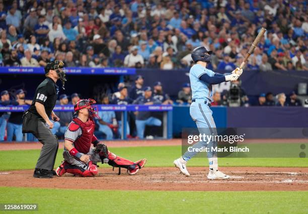 Cavan Biggio of the Toronto Blue Jays hits as three run home run against the Minnesota Twins during the eighth inning in their MLB game at the Rogers...