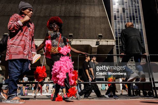 Attendees walk past the Federation of Industries of the State of Sao Paulo building during the Sao Paulo Pride Parade on Avenida Paulista in Sao...