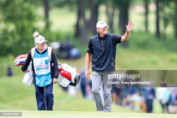 Steve Stricker from Madison, WI waves to the crowd as he walks to the eighteenth green during the final round of the American Family Insurance...