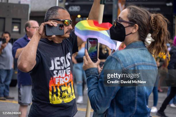 People point smart phones at one another as confrontational Evangelical Christians condemn the annual LA Pride Parade on June 11, 2023 in the...