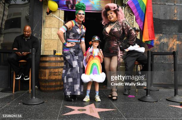 Hollywood, California June 11, 2023-A young girl takers a picture with drag queens along Hollywood Blvd. During the Gay Pride Parade Sunday.