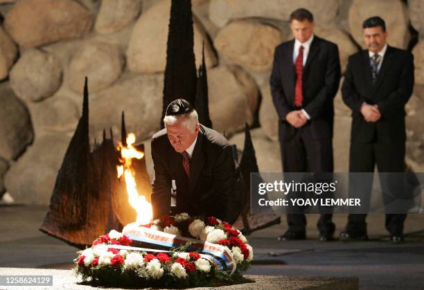 Defense Secretary Robert Gates lays a wreath as his Israeli counterpart Amir Peretz looks on 19 April 2007 at the memorial hall of Yad Vashem. Gates...