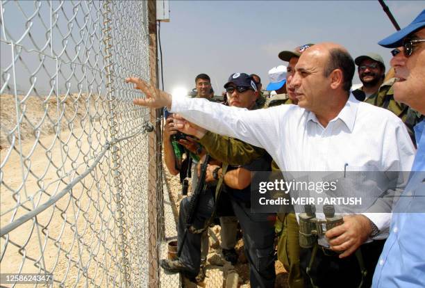 Israeli Defense Minister Shaul Mofaz checks the security fence in the area of Alfei Menashe, in the West Bank, 19 August 2003. Mofaz was quoted as...