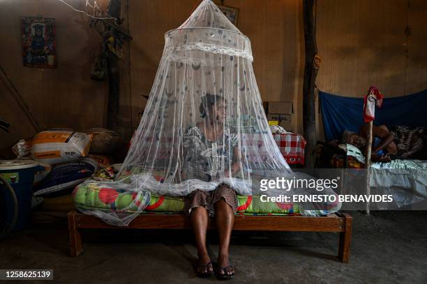 Francisca Sosa , poses for a picture next to her father who suffers from dengue fever, at their house in Catacaos district, Piura department, Peru on...