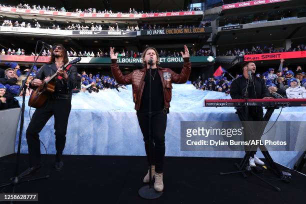 Conrad Sewell performs at on the Big Freeze slide during the 2023 AFL Round 13 match between the Melbourne Demons and the Collingwood Magpies at the...