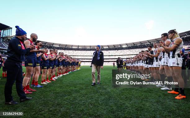 Guard of honour is formed for Neale Daniher during the 2023 AFL Round 13 match between the Melbourne Demons and the Collingwood Magpies at the...